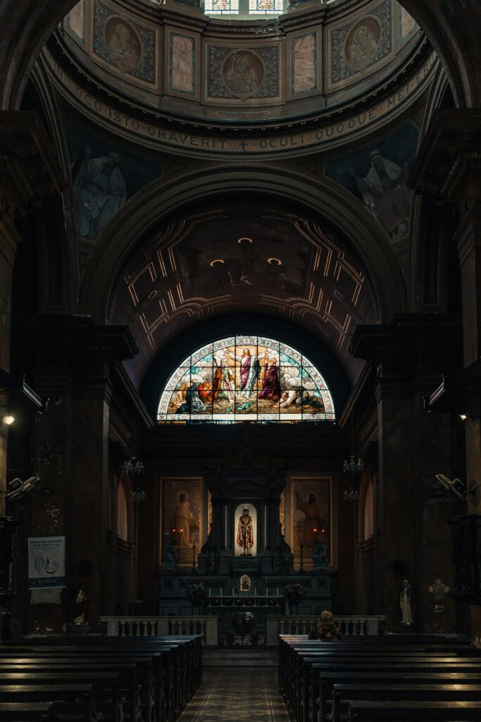 Image of a dark interior of a Catholic basilica.